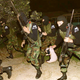 An elite squad of PETA commandos rescues a floppy-eared rabbit (center) from Couture Cosmetics' Norfolk, VA, facility. Forty-nine researchers were executed in the raid.